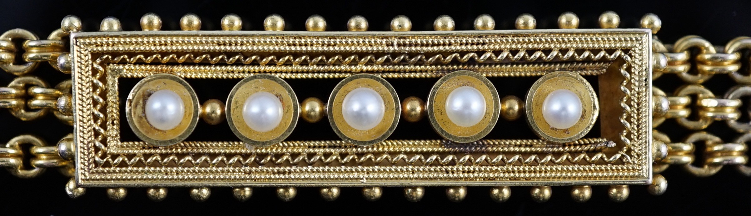 An early 20th century triple strand gold bracelet with central rectangular motif set with five cultured pearls